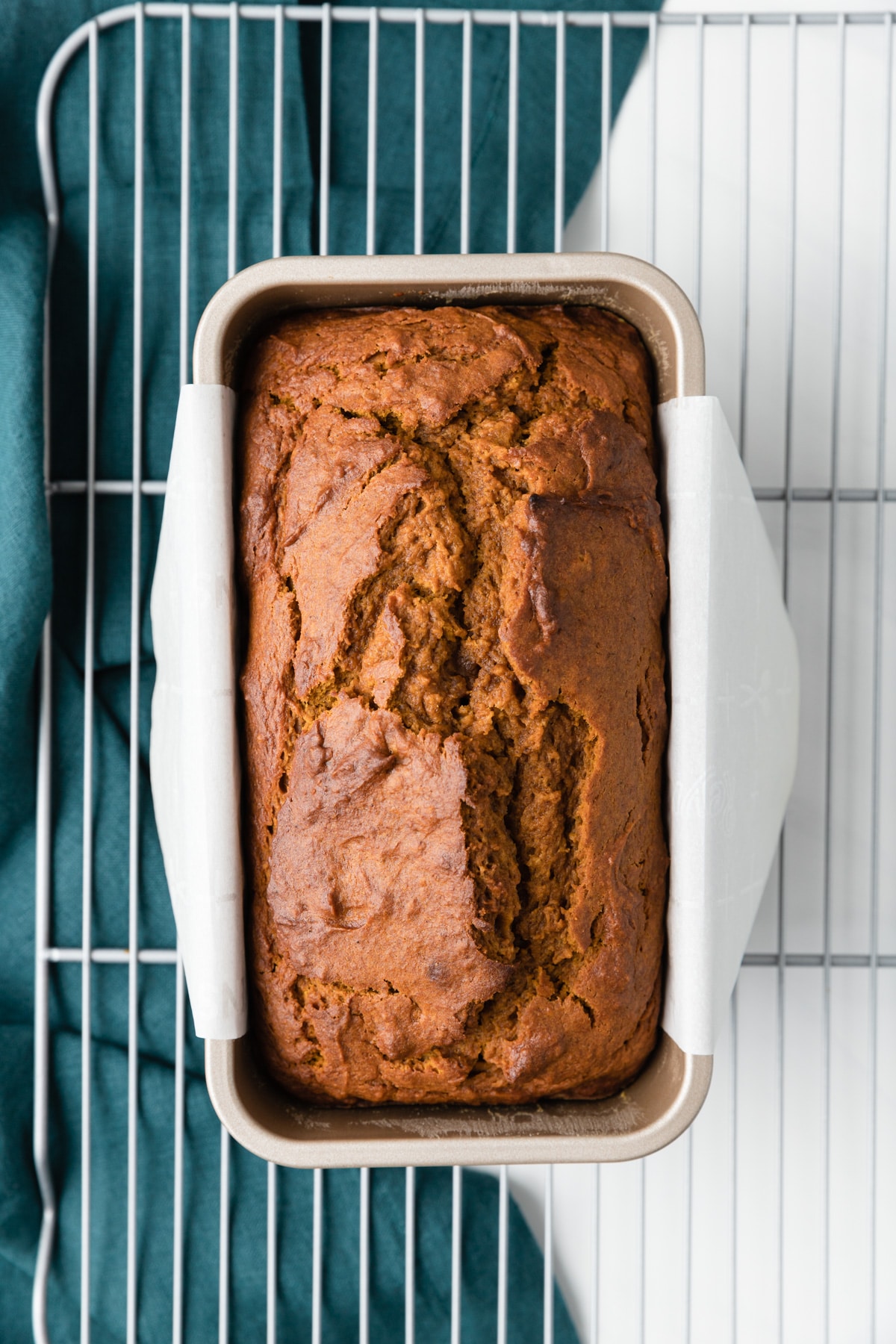 overhead of pumpkin bread in loaf pan on wire rack