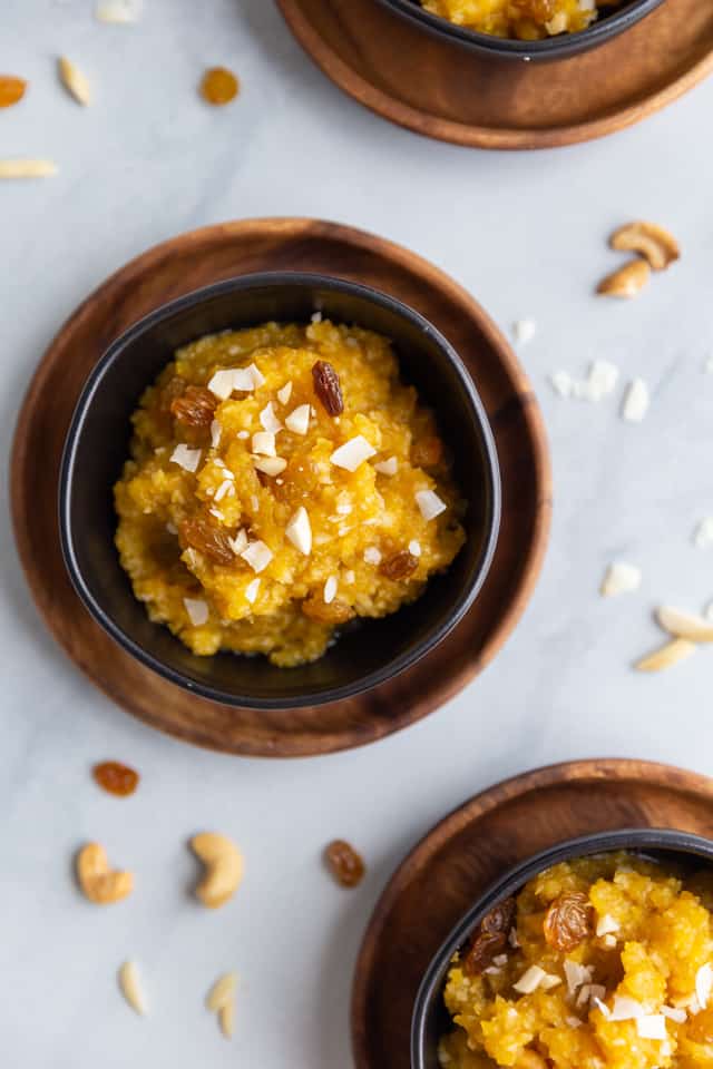 Overhead view of pumpkin coconut halwa in black bowls
