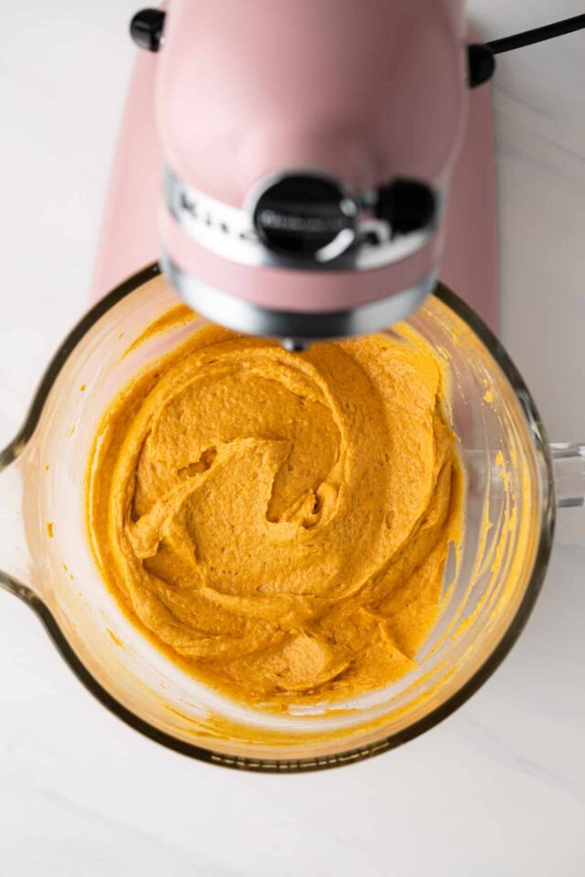 Pumpkin cupcake batter in a stand mixer