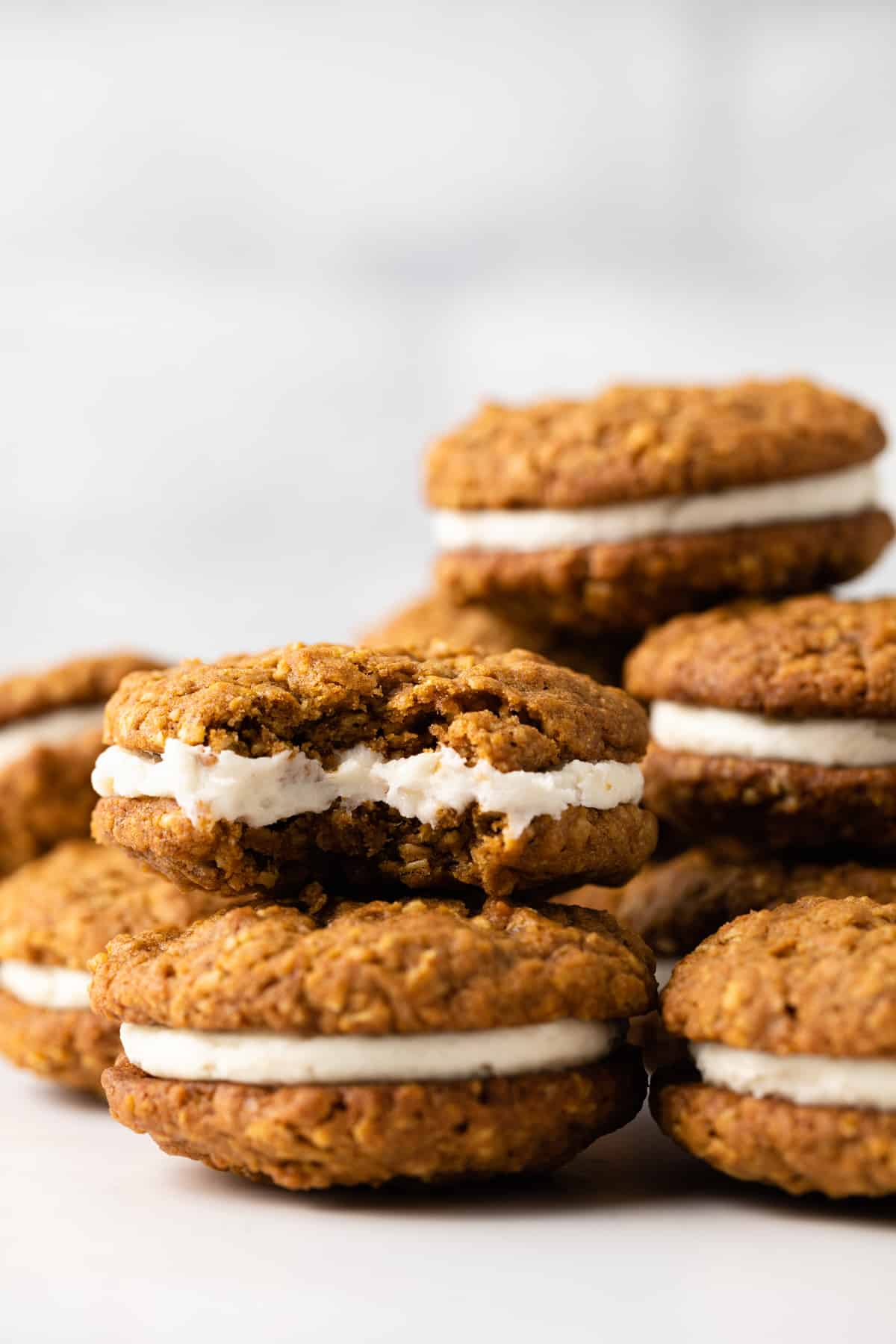 A stack of pumpkin oatmeal cream pies, one with a bite missing