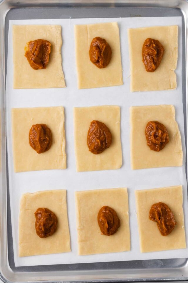 9 rectangles of pastry dough with pumpkin pie fillling
