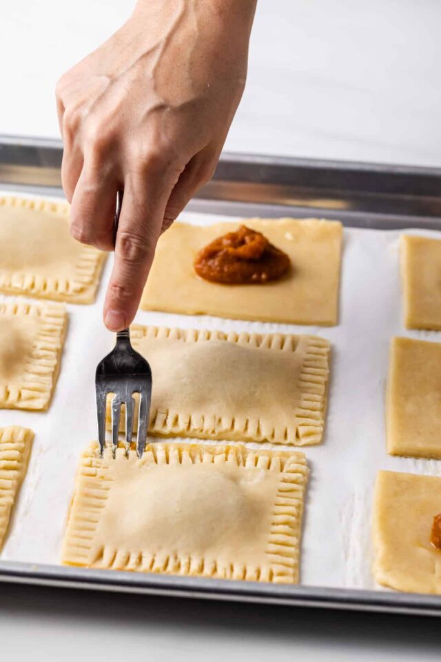 The edges of a pumpkin pie pop tart being sealed