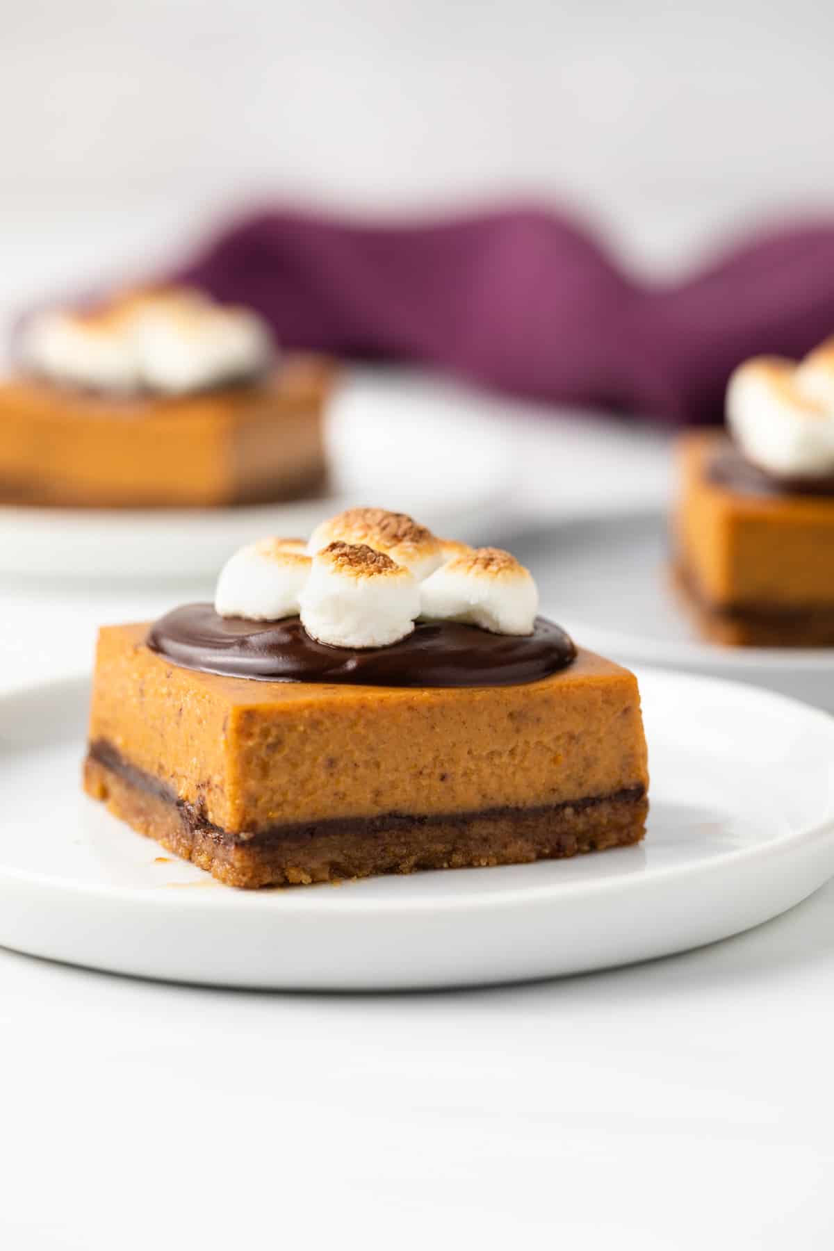 A pumpkin s'mores bar on a white plate