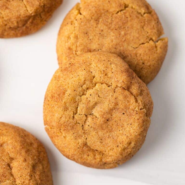 Close up of pumpkin snickerdoodles on white background.