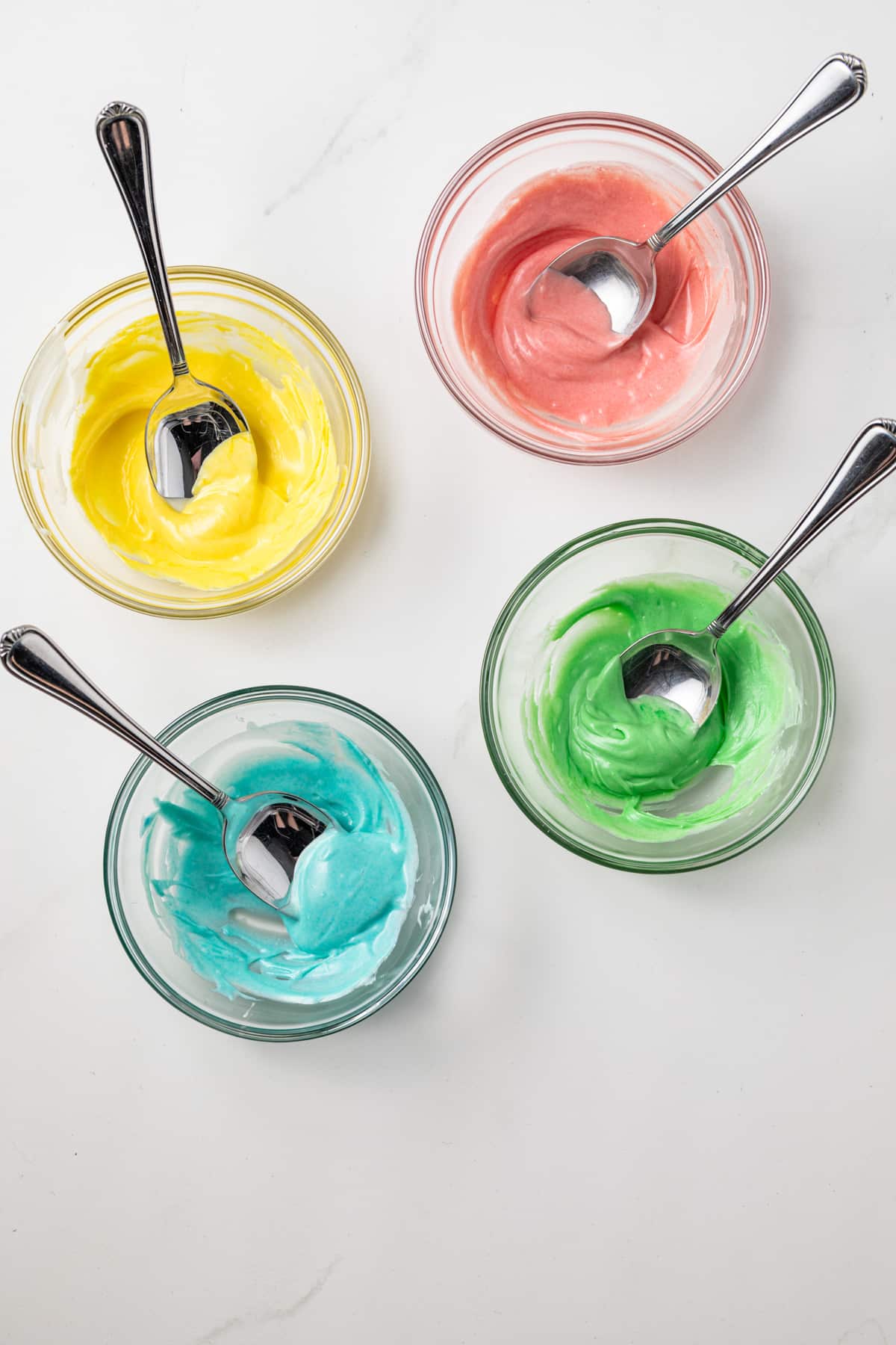 Colored white chocolate in glass bowls.