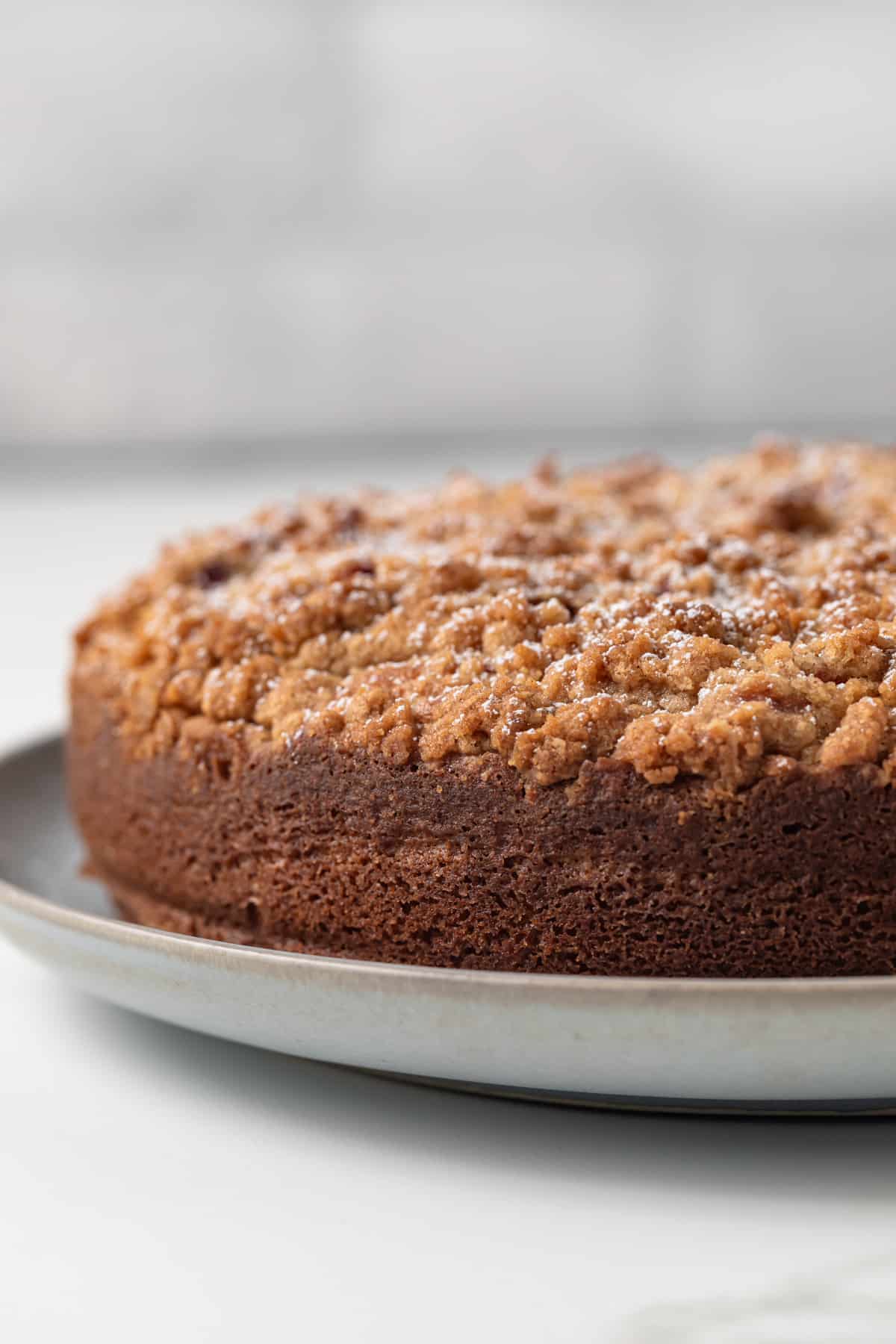 Side view of raspberry coffee cake on a serving platter.