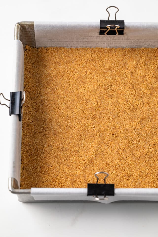 Graham cracker crust in square pan.