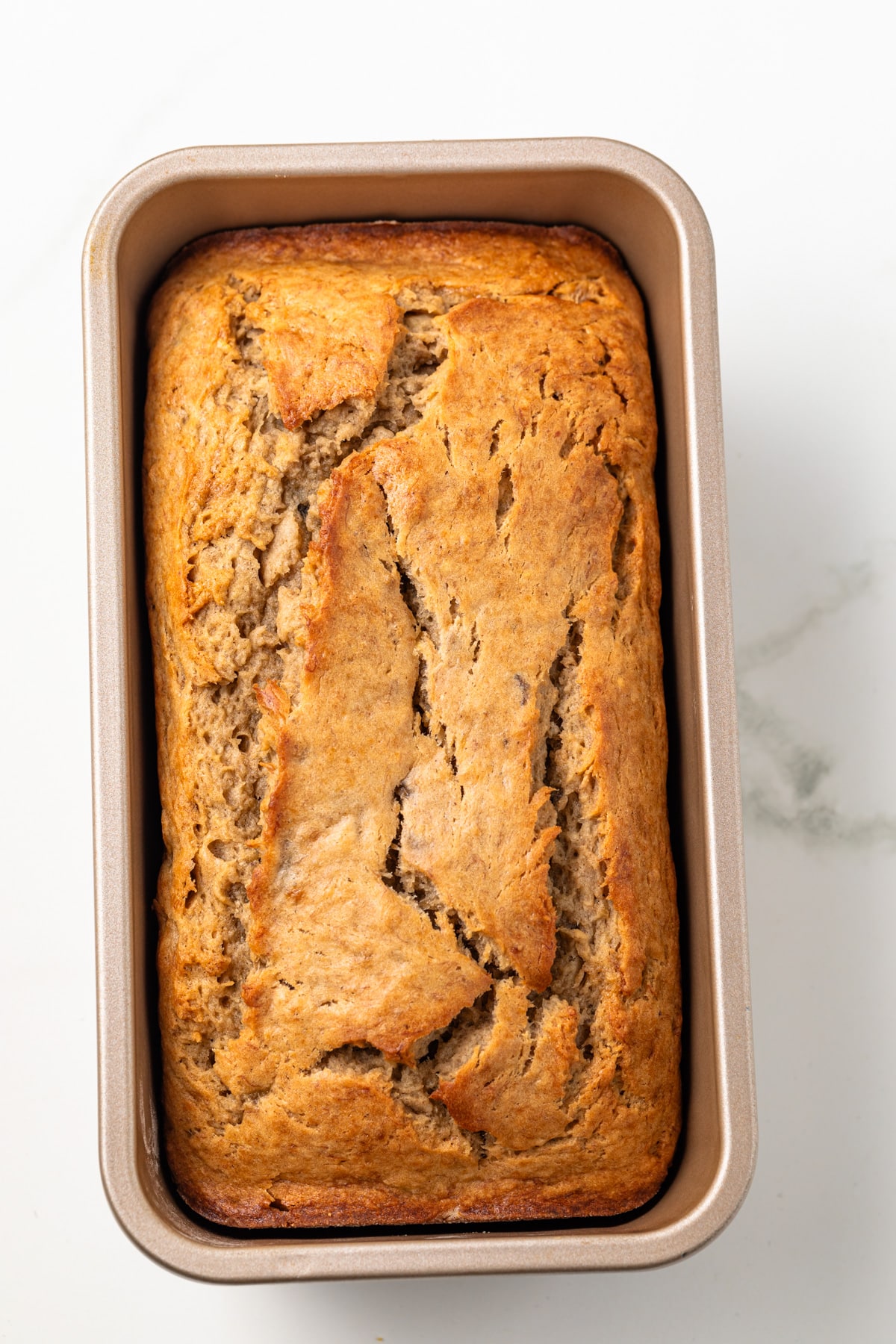 Baked banana bread in loaf pan.