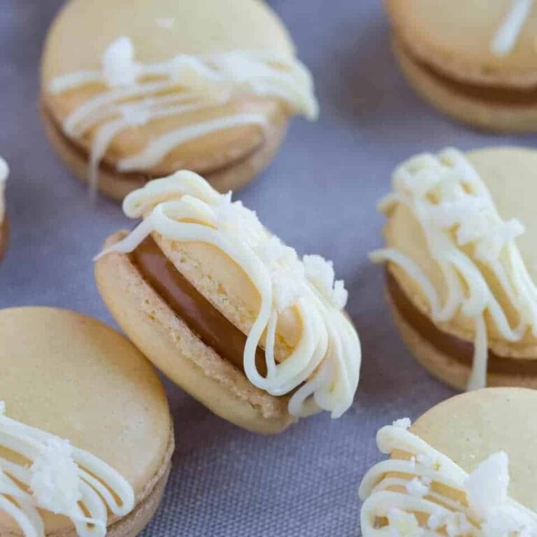 angled view of Salted Caramel Ginger Macarons on a fabric background