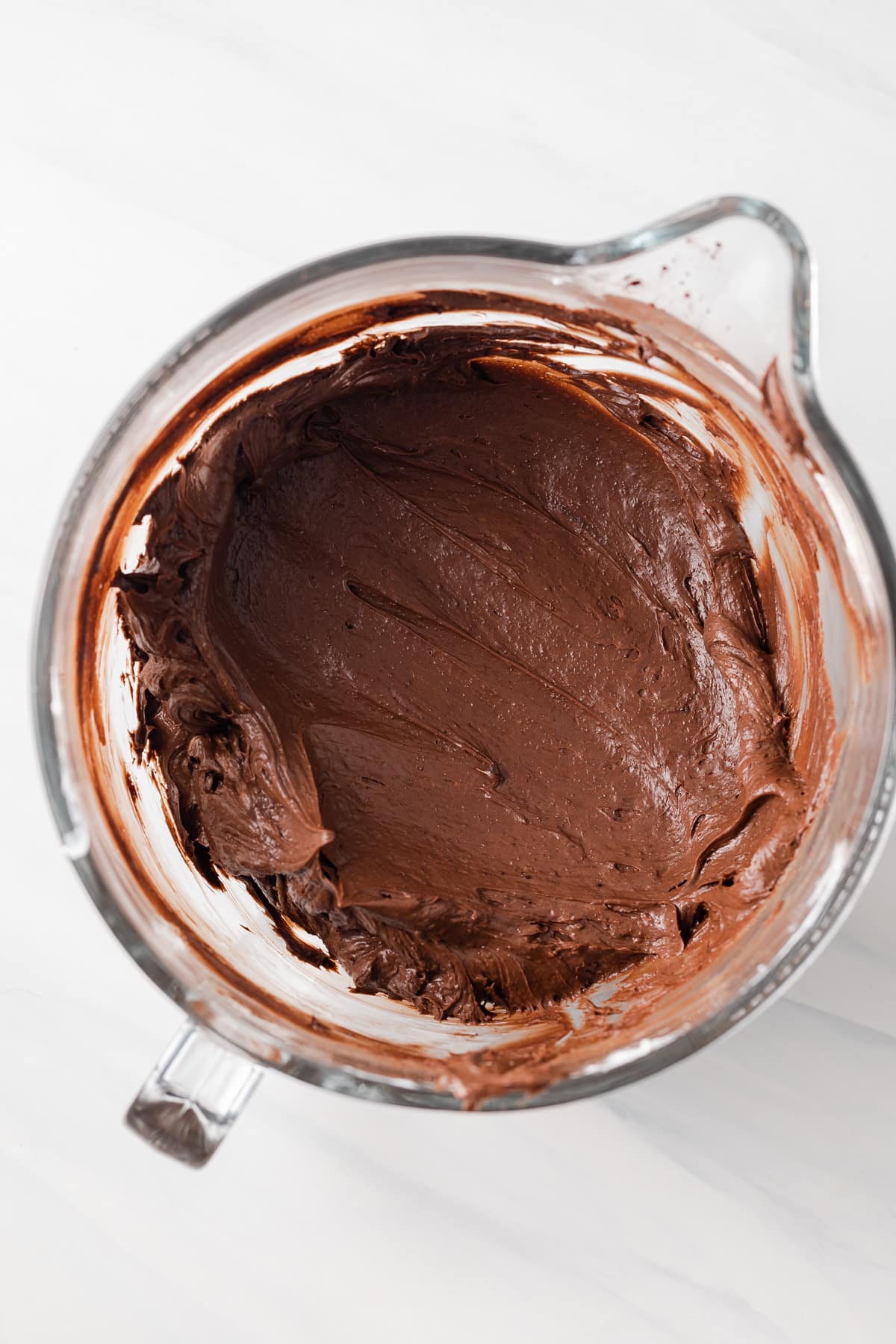 Chocolate cheesecake batter in glass bowl.