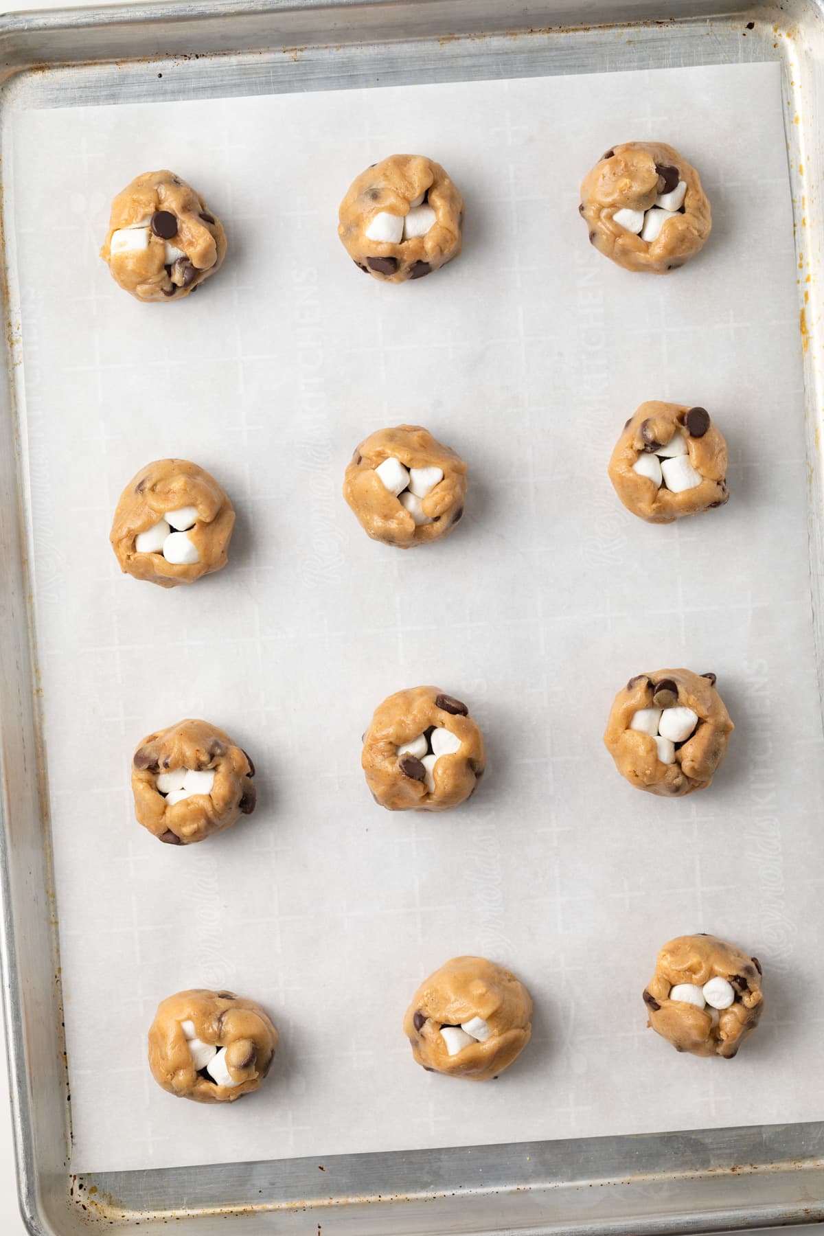 Unbaked s'mores cookies on baking sheet.