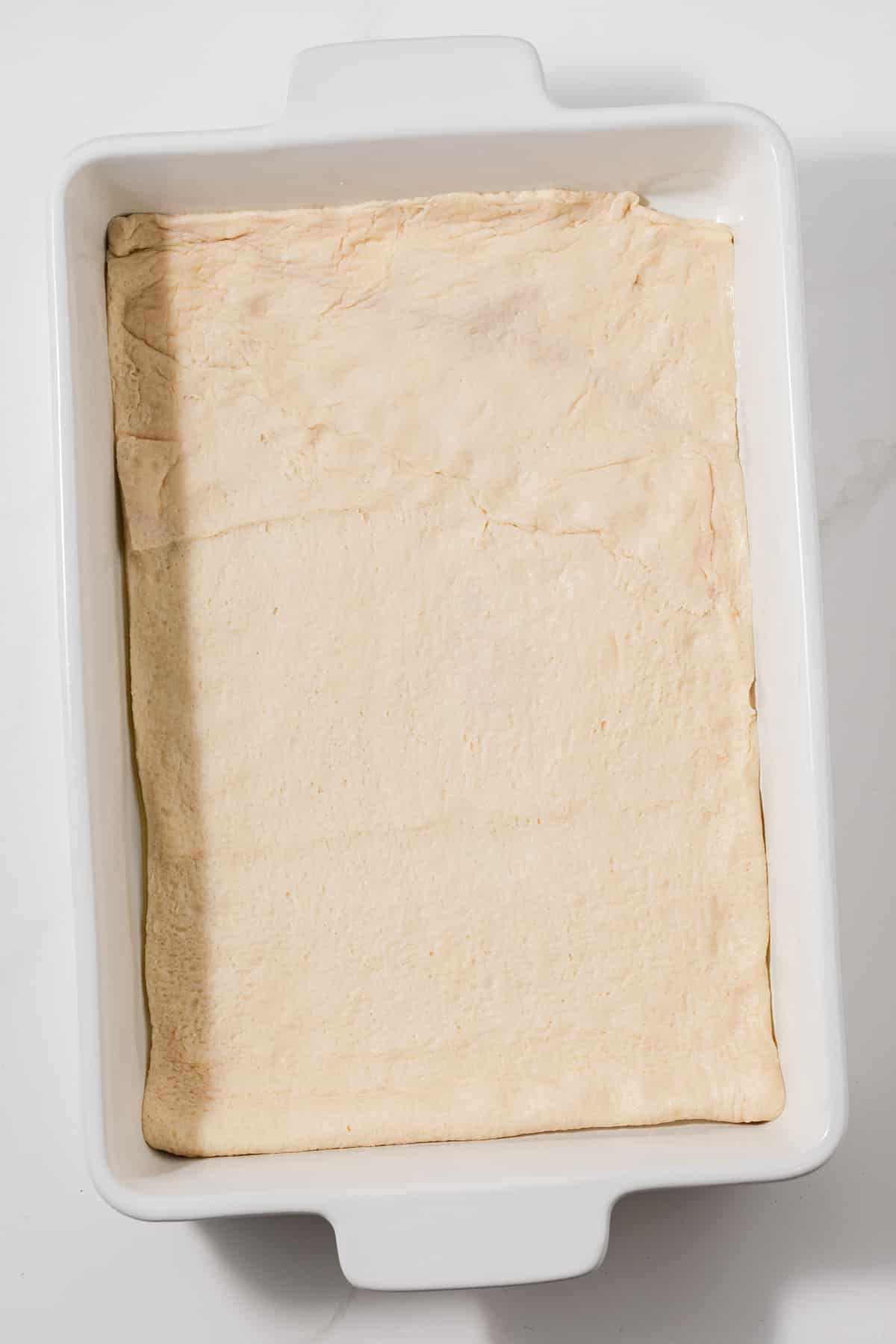 Pastry dough in bottom of baking dish.