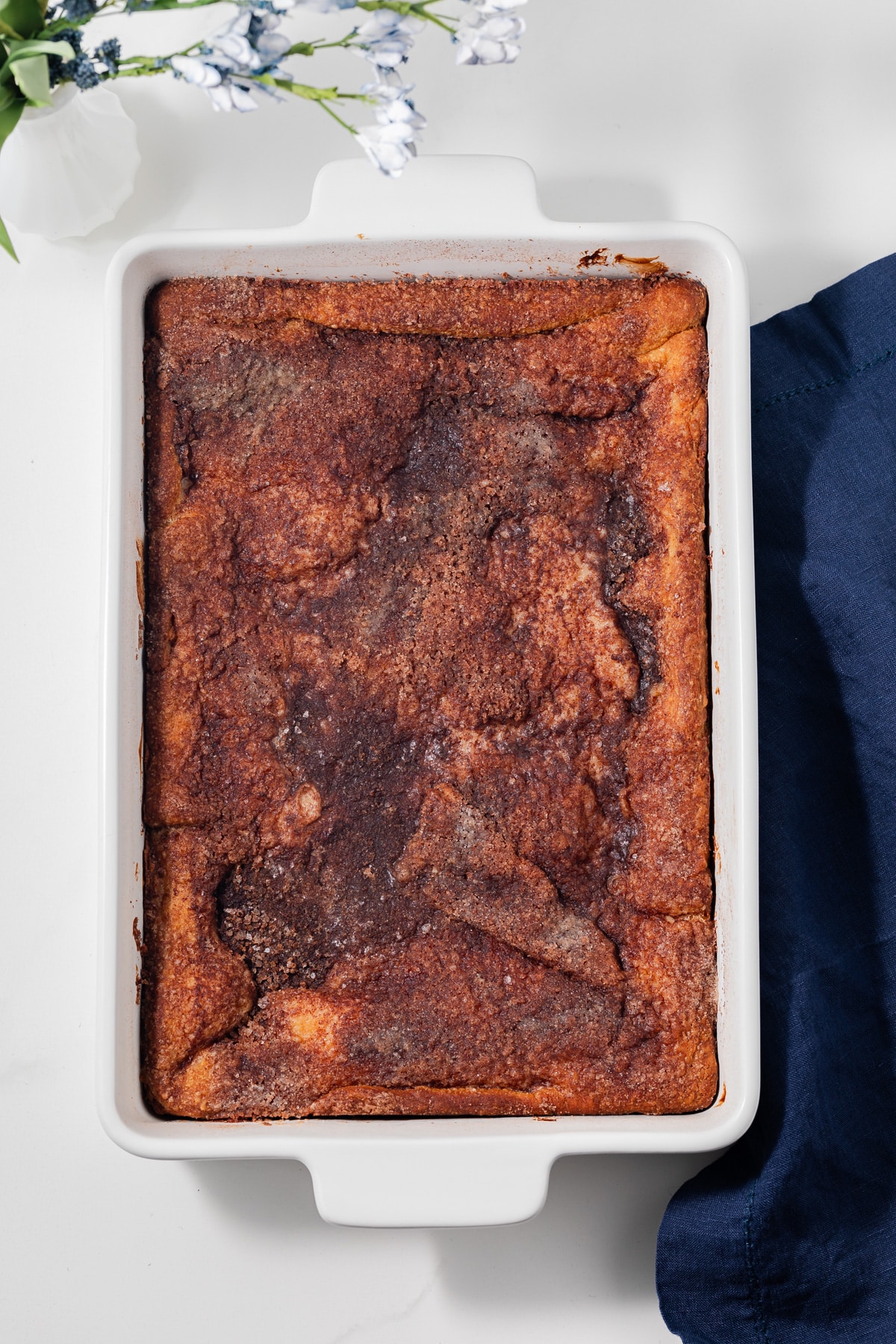 Overhead view of sopapilla cheesecake in white baking dish.