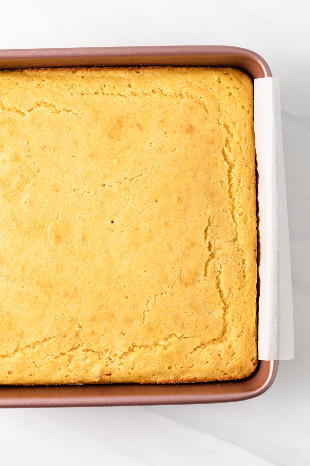 baked cornbread in a pink baking pan