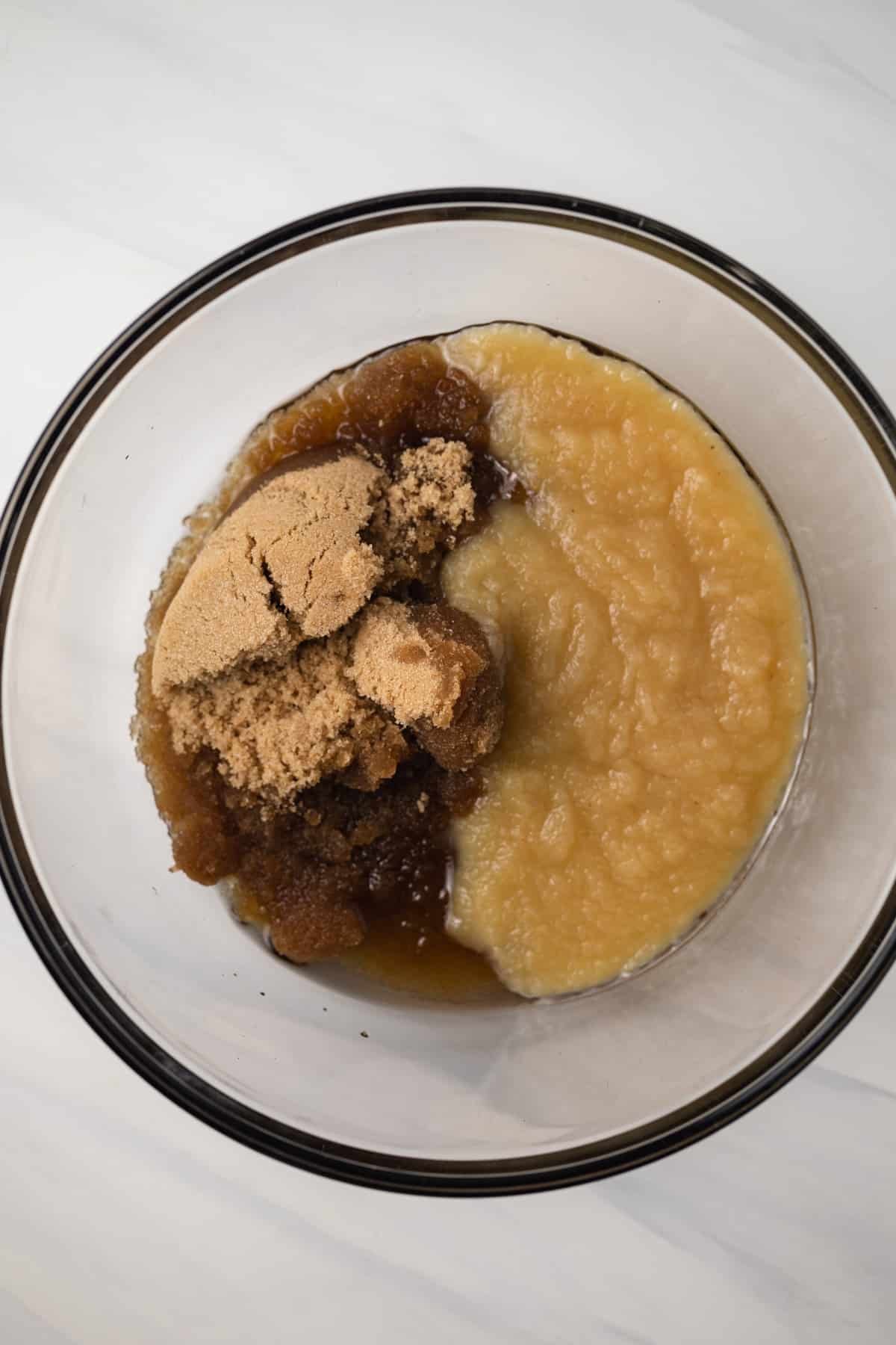 Oil, applesauce, and brown sugar in glass bowl.