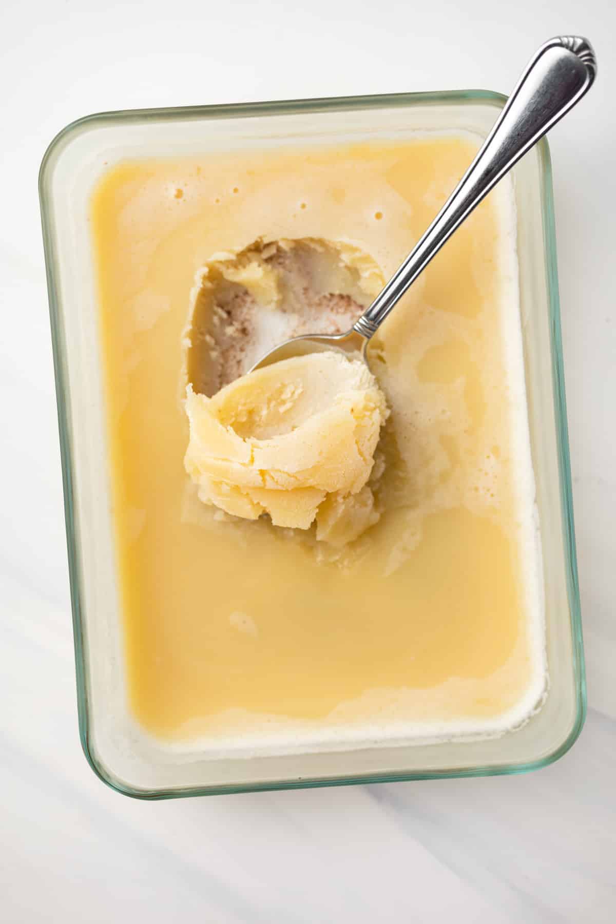 Solidified brown butter in glass dish.