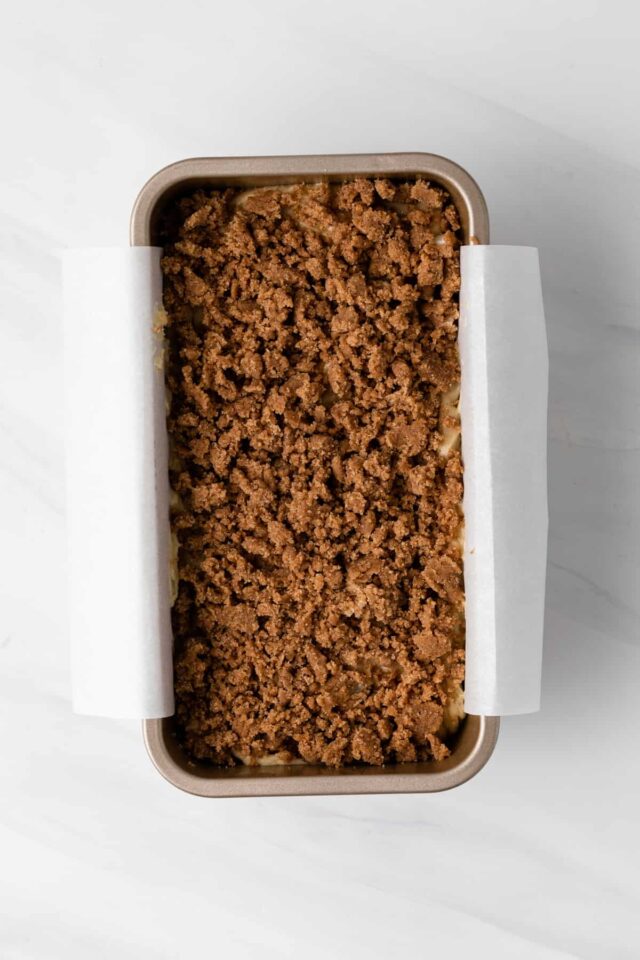 Spiced pear bread in a pan with cinnamon sugar topping