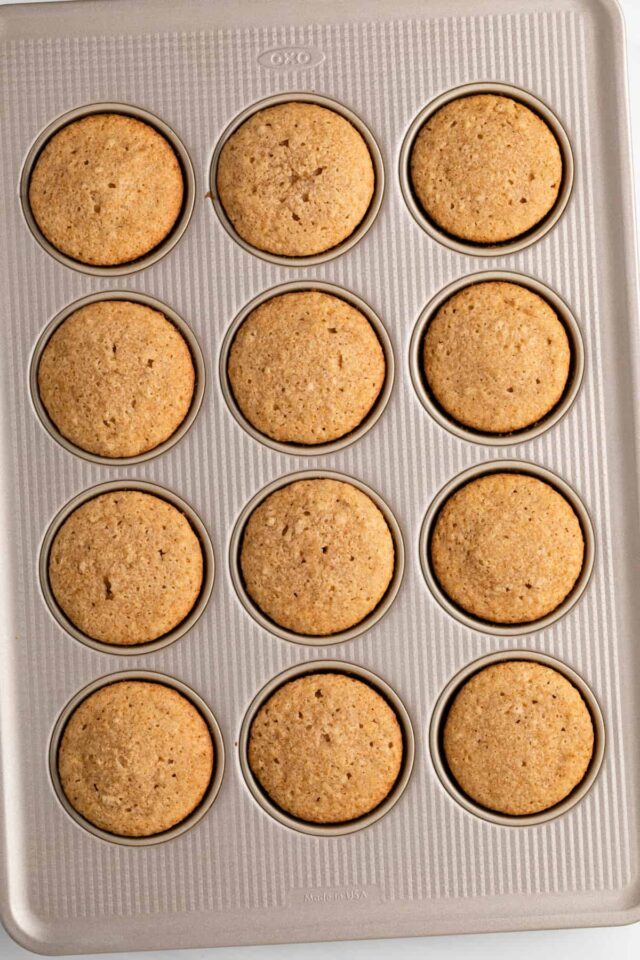 Baked apple spice cupcakes in a muffin pan
