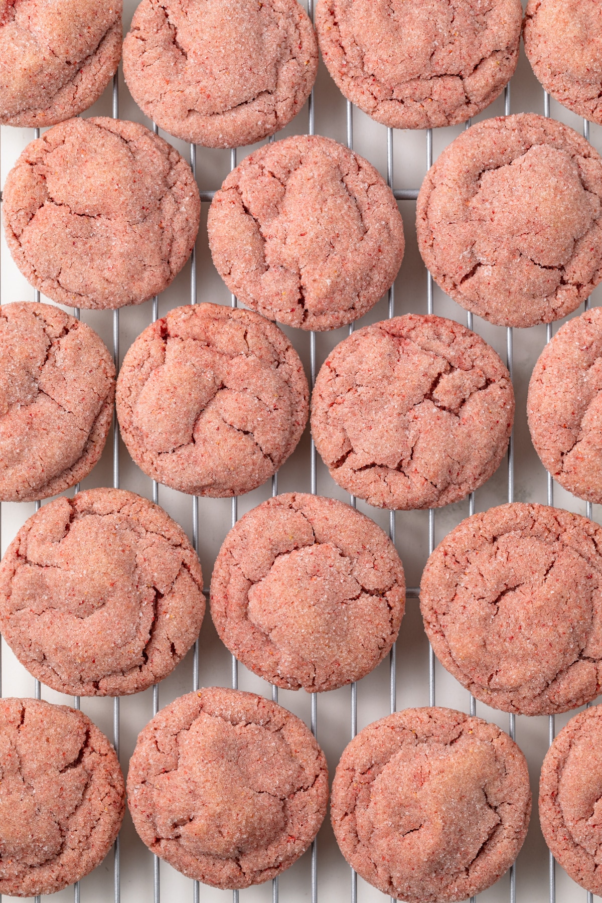 Strawberry cookies on a cooling rack.