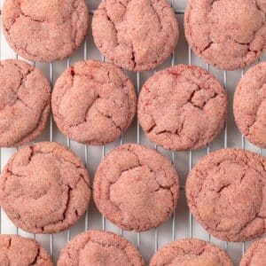 Strawberry cookies on a cooling rack.