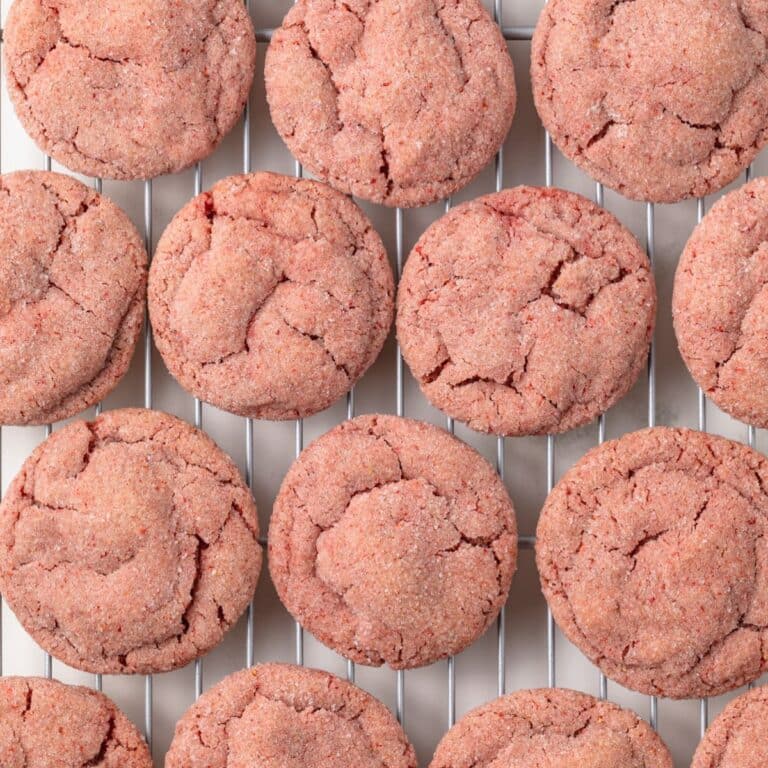 Strawberry cookies on a cooling rack.