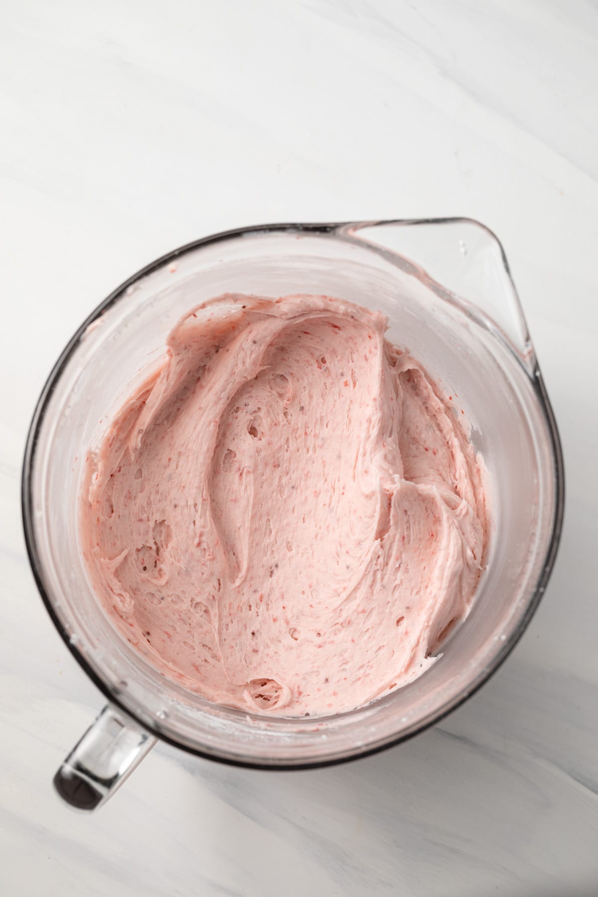 Strawberry frosting in glass bowl.