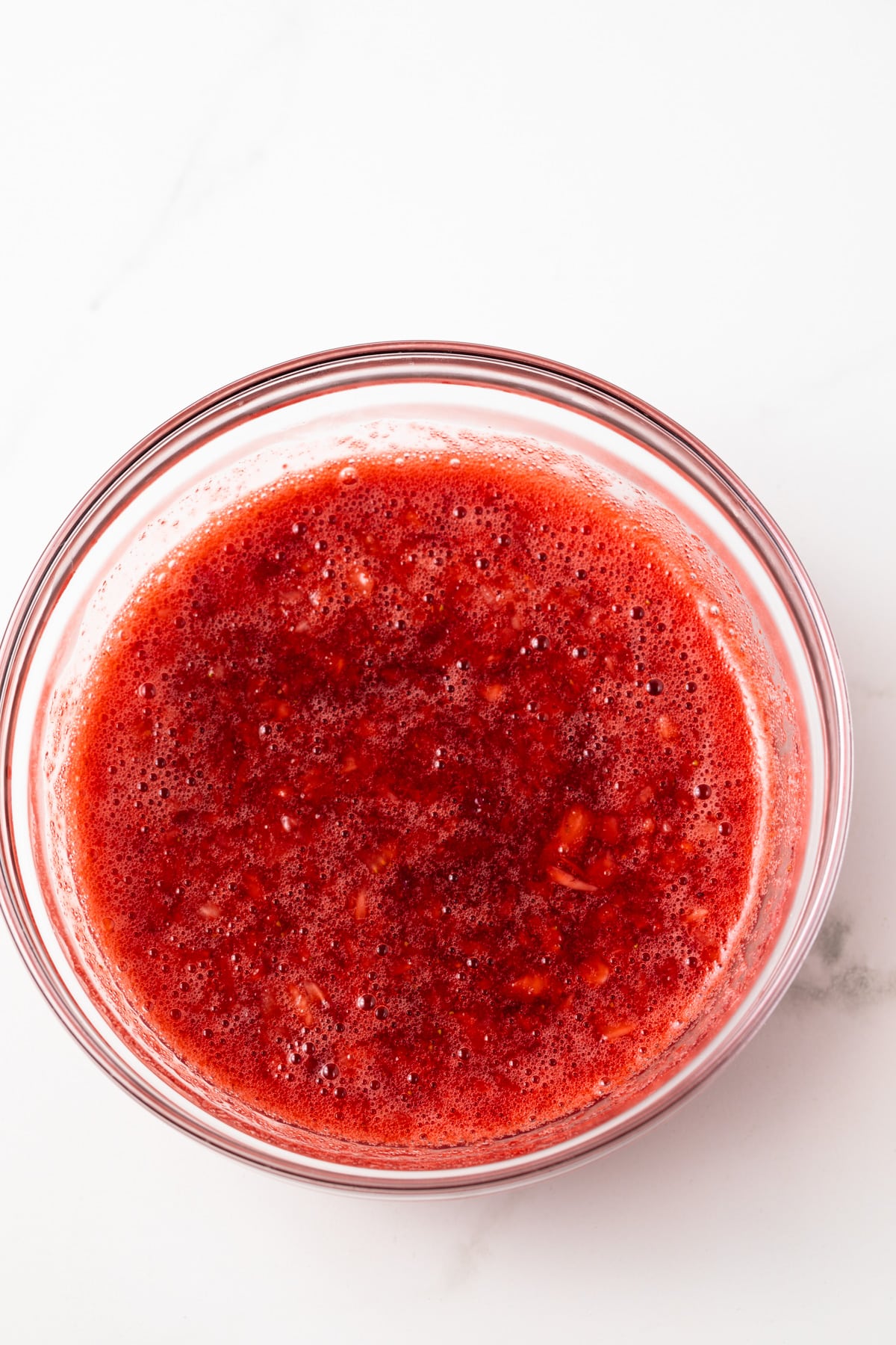 Strawberry puree in a glass bowl.