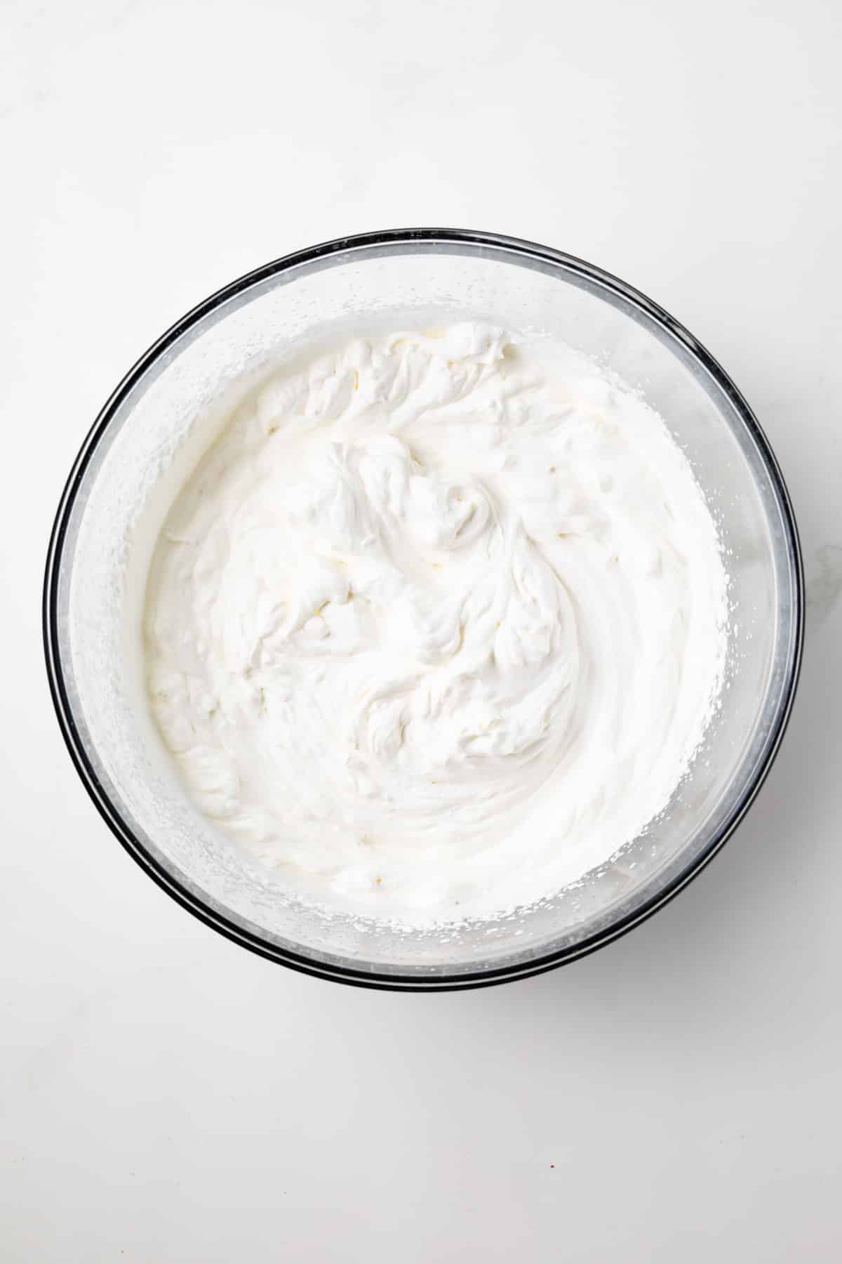 Whipped cream in a glass bowl.