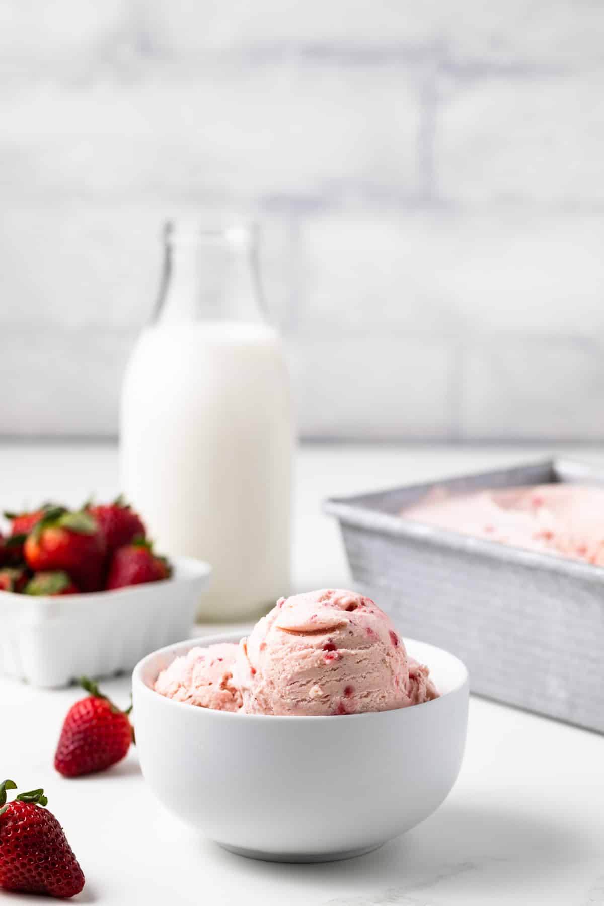 Side view of strawberry ice cream in a bowl.