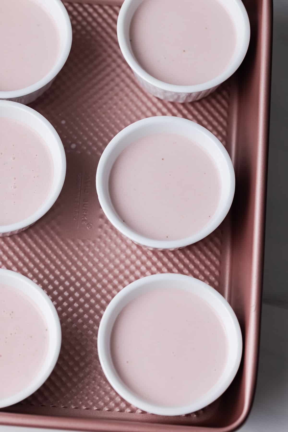 strawberry panna cotta in white ramekins