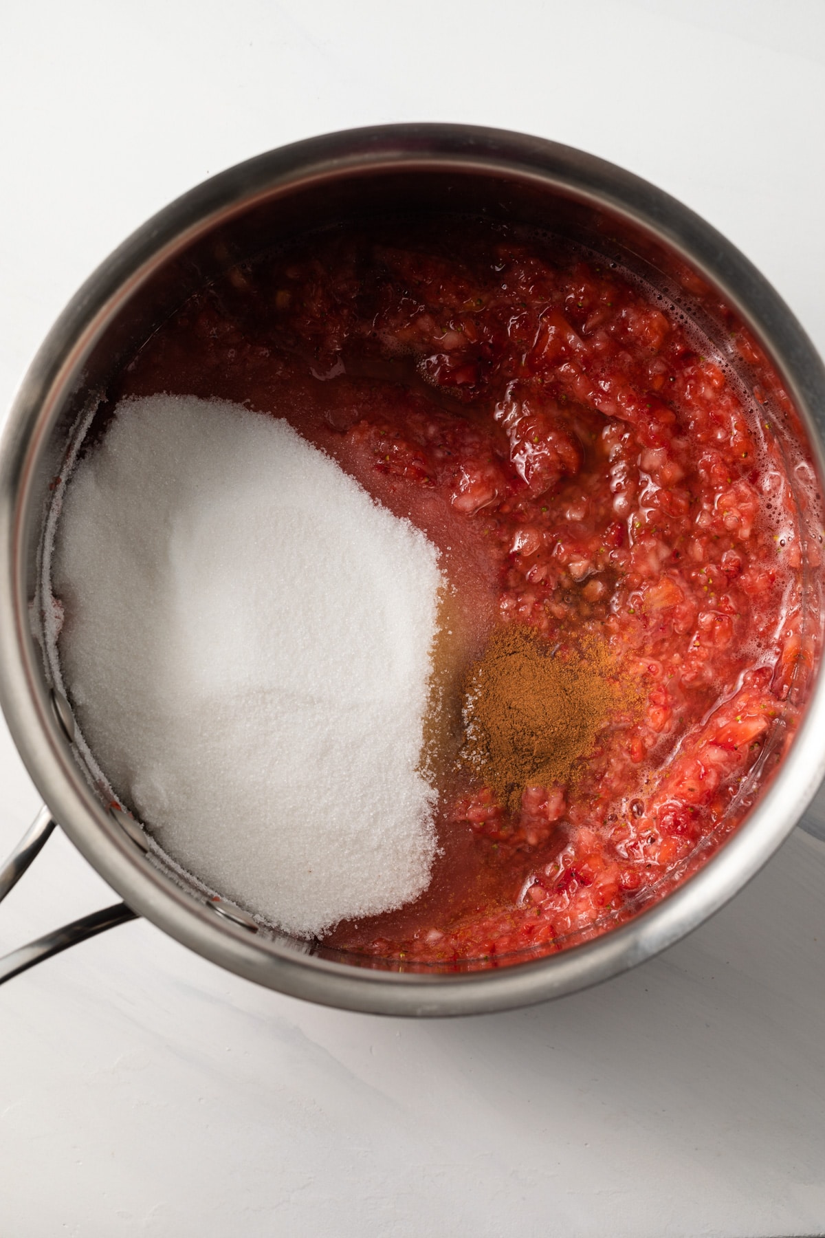 Strawberry puree, sugar, and cinnamon in saucepan.