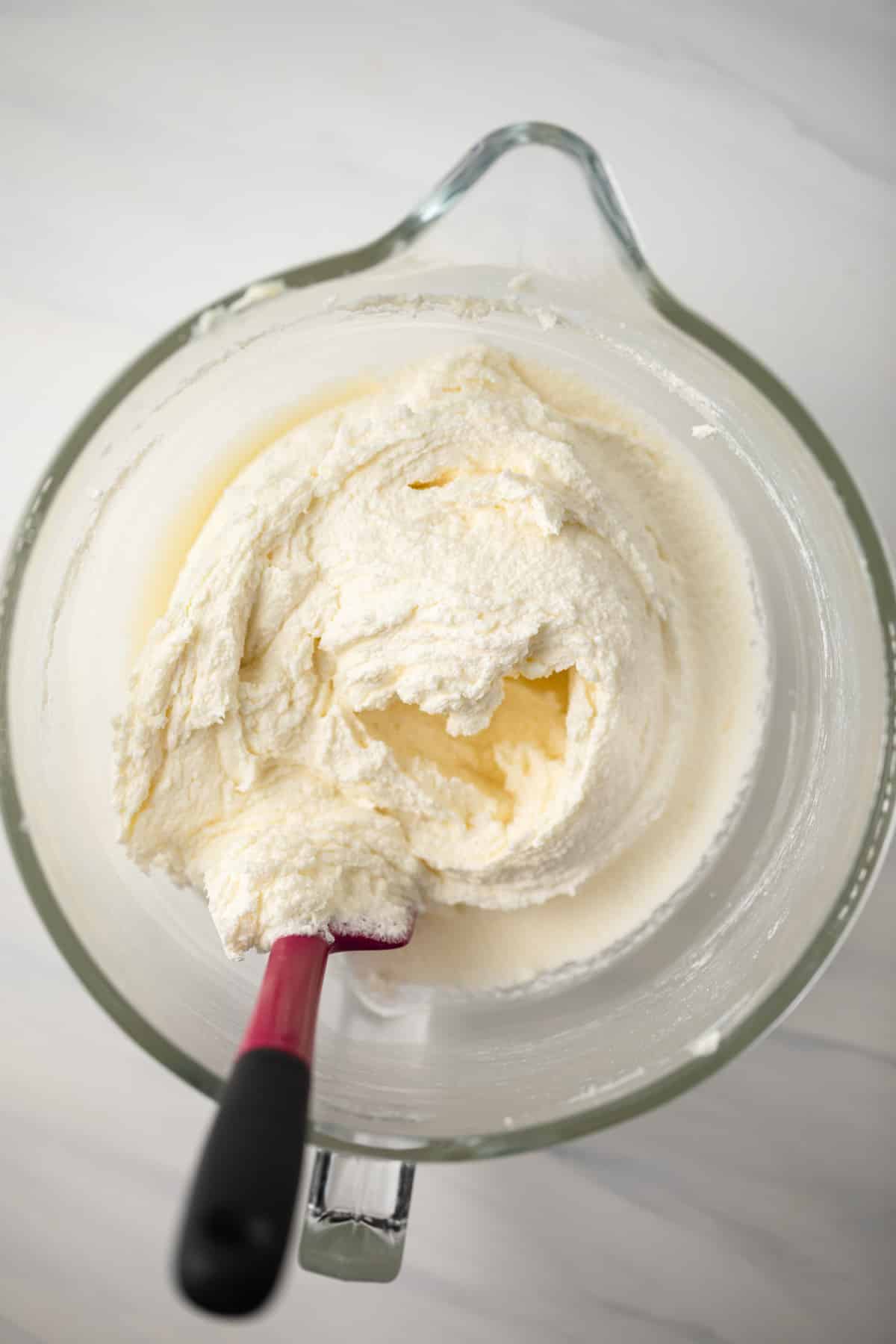 Creamed butter and sugar in glass bowl.