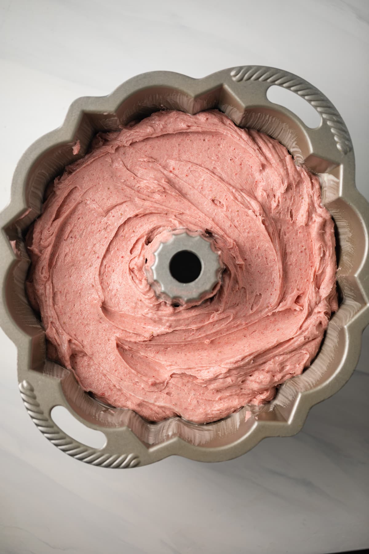 Strawberry pound cake batter in bundt pan.