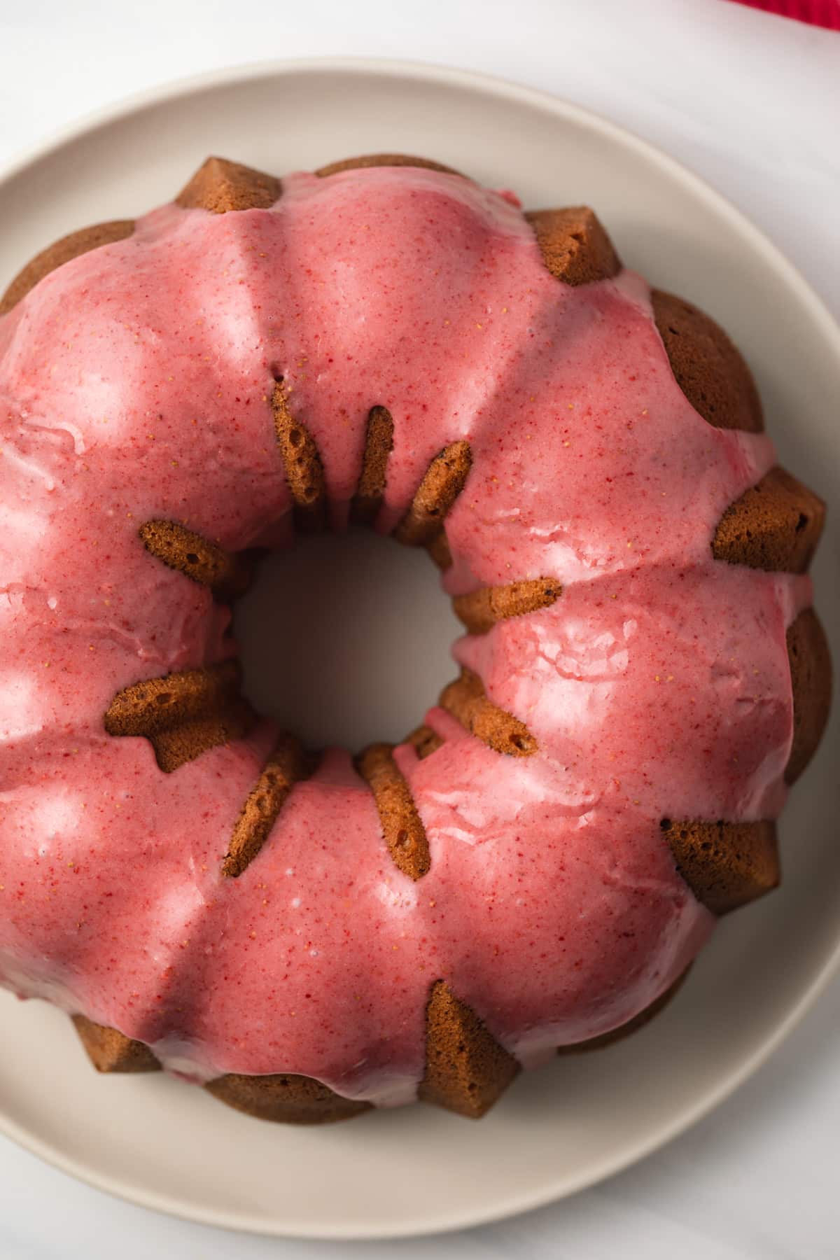 Close up of strawberry pound cake on cake plate.