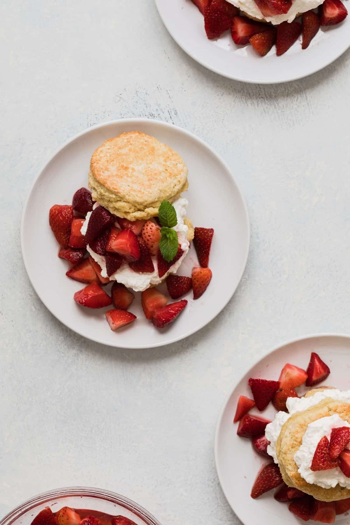 overhead view of strawberry shortcakes on white plates