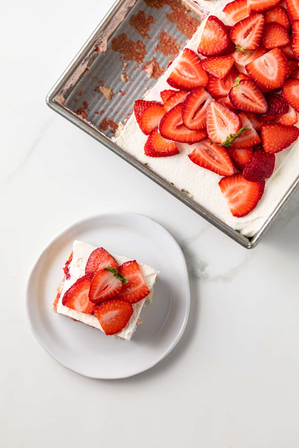 Slice take out of pan of strawberry tiramisu.