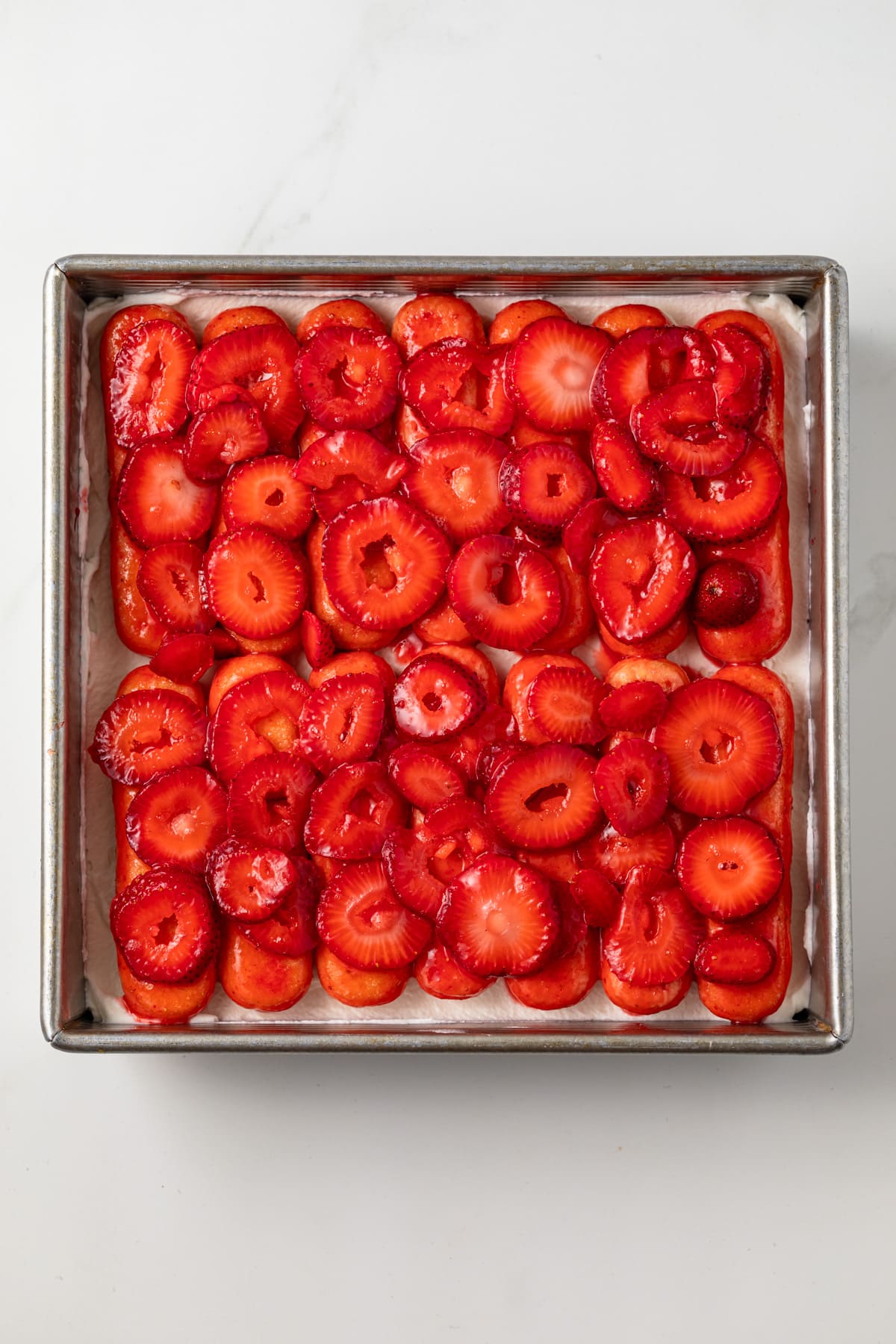 Layers of ladyfingers, strawberries, and whipped cream.