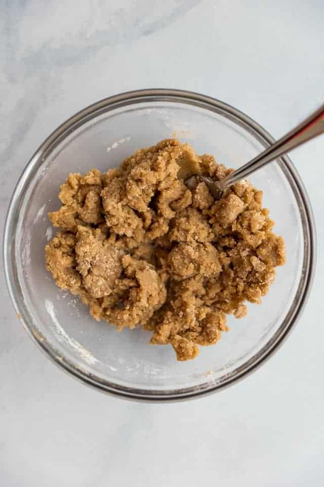overhead view of streusel topping in a glass bowl