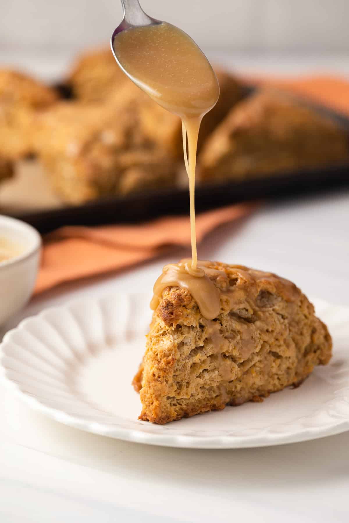 Glaze drizzled over sweet potato scones.