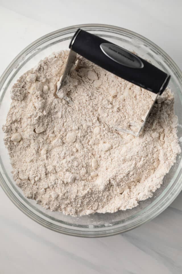 Butter cut into flour in glass bowl.