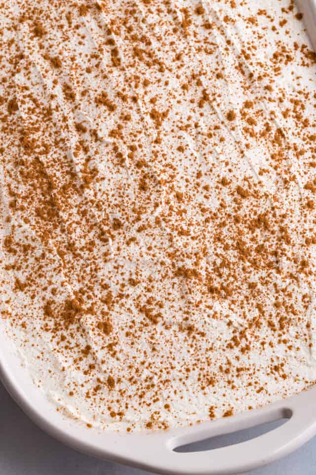 overhead view of tres leches cake in a white pan