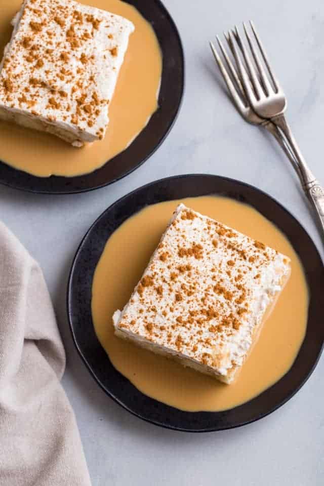 overhead view of tres leches cake on a dark blue plate