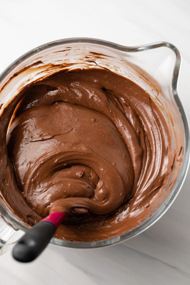 Chocolate cheesecake batter in glass bowl.