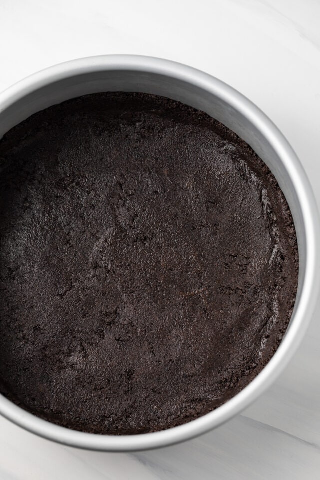 Chocolate cookie crust in round pan.