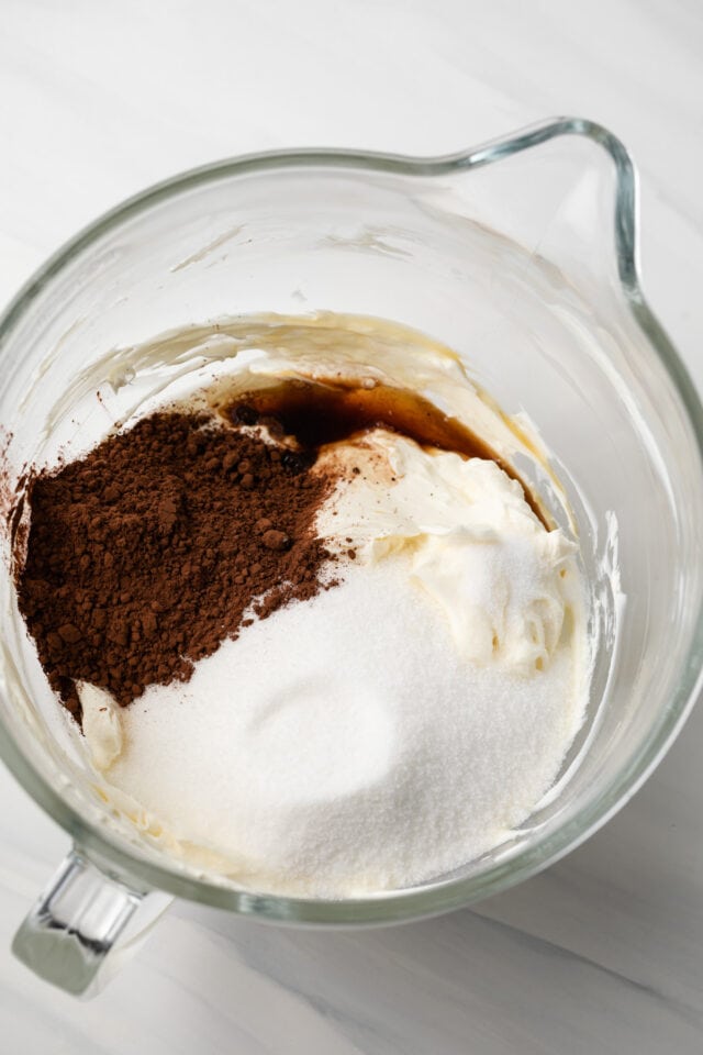 Creamed cream cheese, cocoa powder, and sugar in bowl.