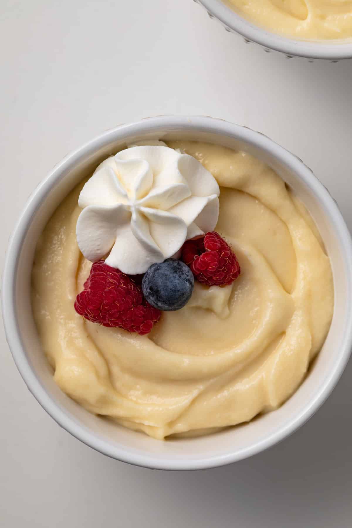 Close up of vanilla pudding in white bowl.