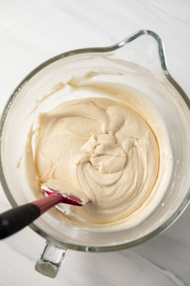 Vanilla cupcake batter in glass bowl.