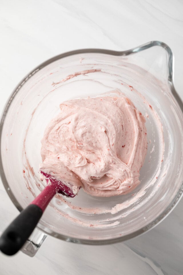 Strawberry frosting in glass bowl.