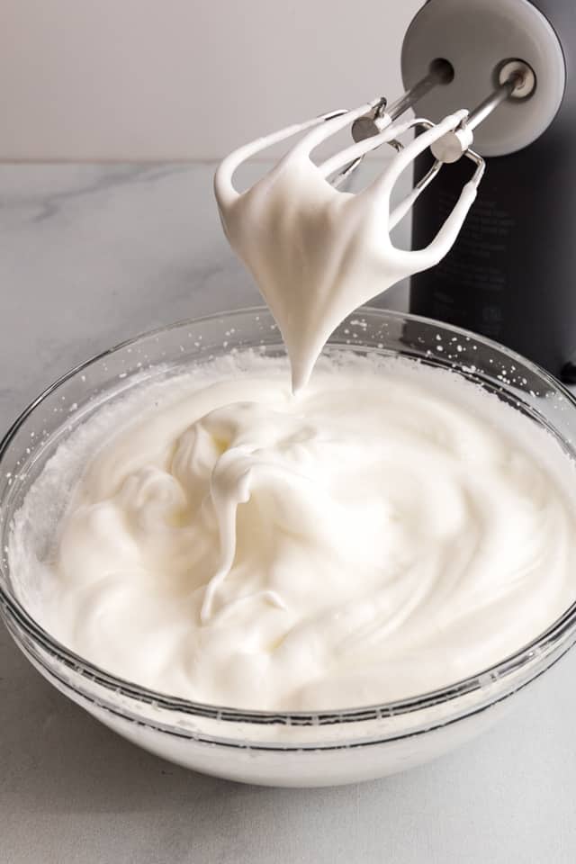 whipped egg whites in a glass bowl