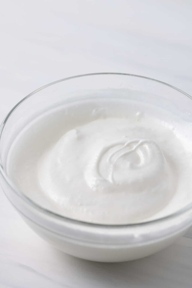 Whipped egg whites in a glass bowl